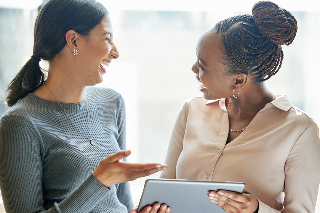 Women, office and smile on tablet for internet with research, teamwork and collaboration as accountant. Partner, happy and learning with online information for communication and networking for work.